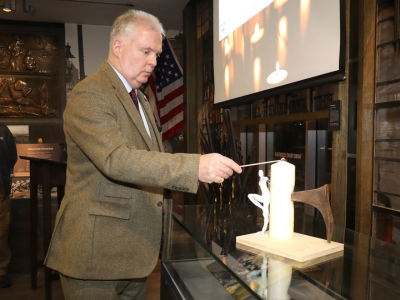 NIWM Chairman, Don Bigger, lights a candle on Holocaust Memorial Day 2025