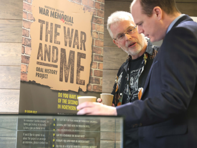 Gordon Lyons MLA, Minister for Communities, talking to NIWM Collections Officer, Dr James O'Neill